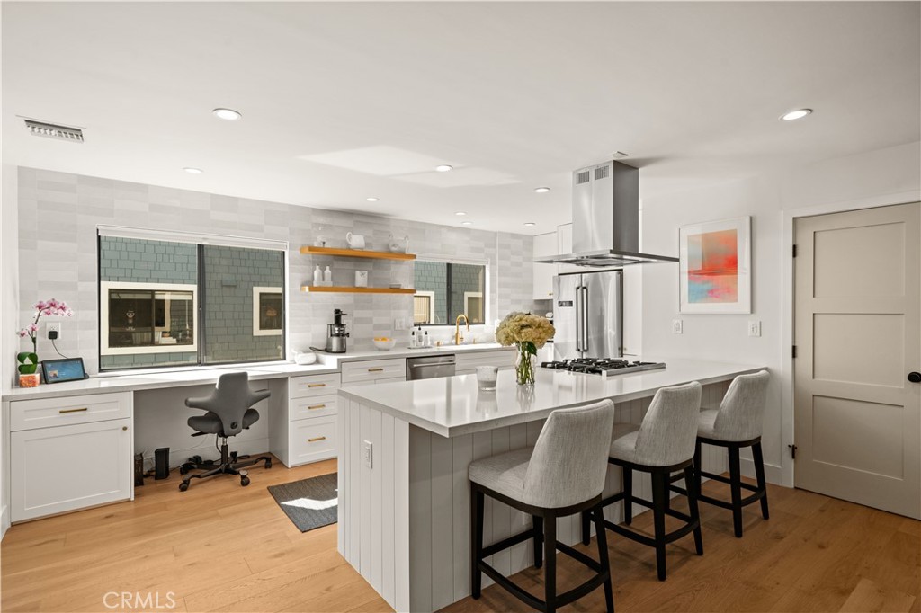 3716 Vía Dolce Marina del Rey, CA 90292 - Photo 11 of 55 a kitchen with a table chairs refrigerator and cabinets