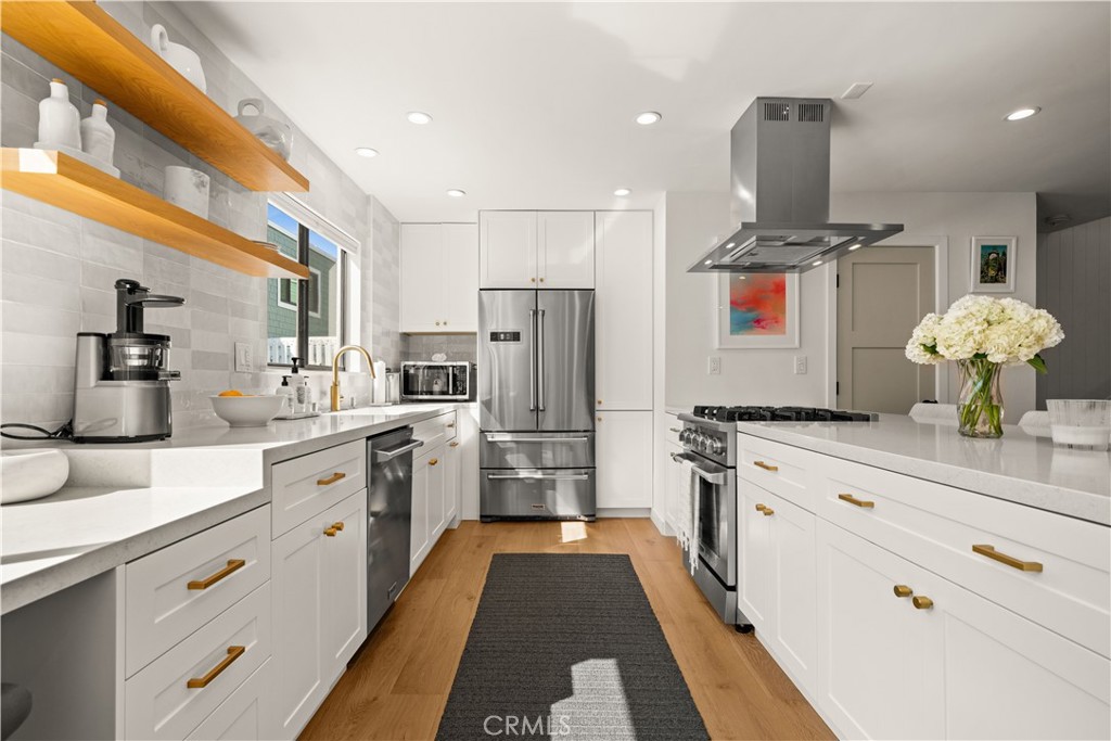 3716 Vía Dolce Marina del Rey, CA 90292 - Photo 13 of 55 a kitchen with kitchen island granite countertop stainless steel appliances lots of counter top space