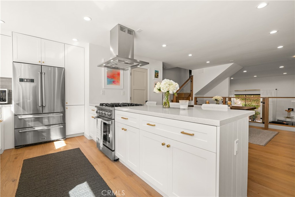 3716 Vía Dolce Marina del Rey, CA 90292 - Photo 17 of 55 a kitchen with stainless steel appliances kitchen island granite countertop a refrigerator and a stove top oven