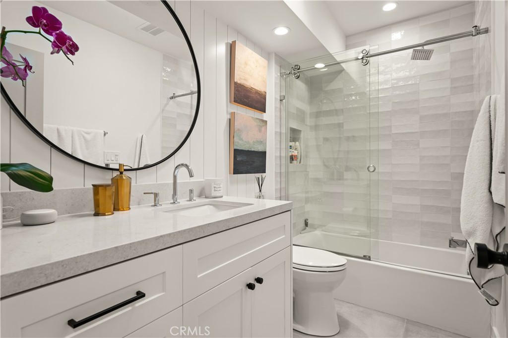 3716 Vía Dolce Marina del Rey, CA 90292 - Photo 31 of 55 a bathroom with a granite countertop sink toilet mirror and shower