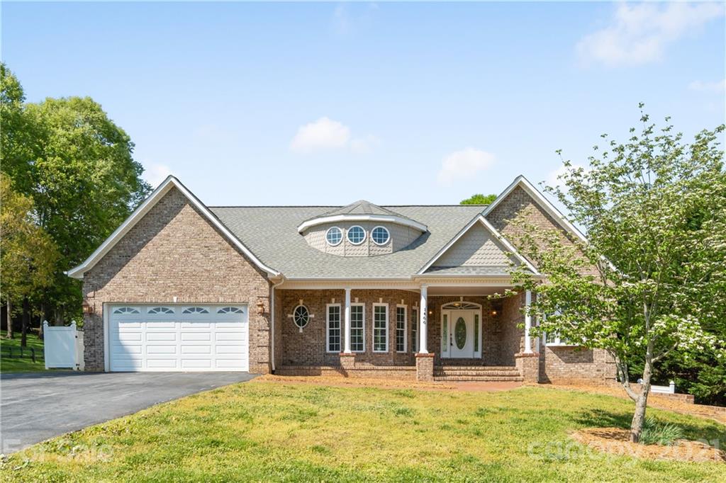 a view of a house with a yard and garage