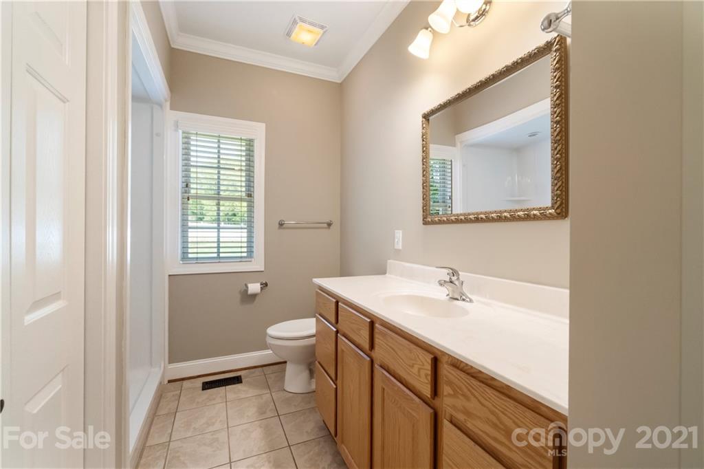 1466 Victorian Hills Circle Conover, NC 28613 - Photo 13 of 40 a bathroom with a sink a toilet and mirror