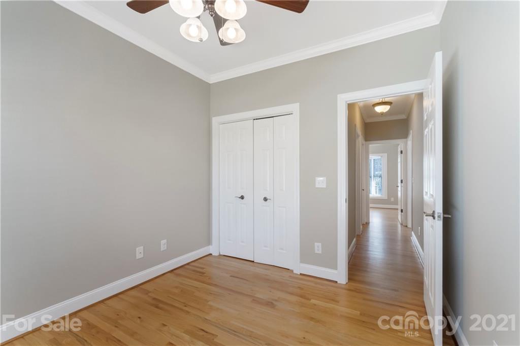 1466 Victorian Hills Circle Conover, NC 28613 - Photo 16 of 40 a view of a hallway with wooden floor and a chandelier