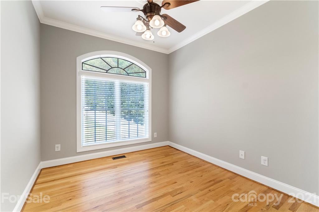 1466 Victorian Hills Circle Conover, NC 28613 - Photo 17 of 40 a view of an empty room with wooden floor and a window