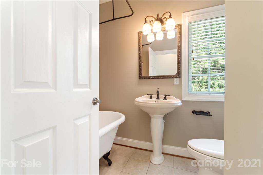 1466 Victorian Hills Circle Conover, NC 28613 - Photo 18 of 40 a bathroom with a sink toilet mirror and tub
