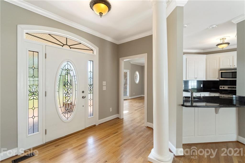 1466 Victorian Hills Circle Conover, NC 28613 - Photo 3 of 40 a view of a hallway view with wooden floor and staircase