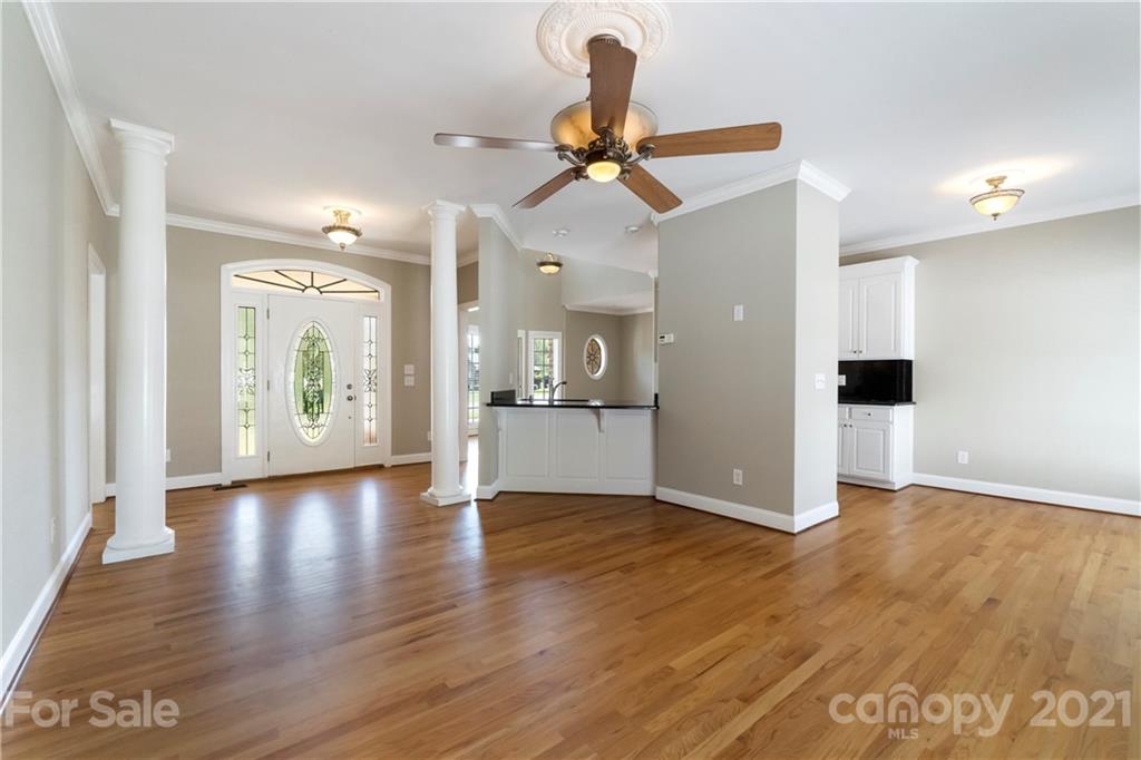 1466 Victorian Hills Circle Conover, NC 28613 - Photo 4 of 40 a view of a hallway with wooden floor and a kitchen