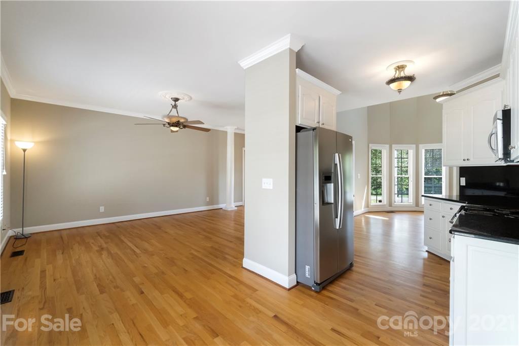 1466 Victorian Hills Circle Conover, NC 28613 - Photo 6 of 40 a view of a kitchen with wooden floor and a refrigerator