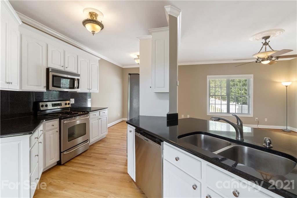 1466 Victorian Hills Circle Conover, NC 28613 - Photo 9 of 40 a kitchen with granite countertop a sink stainless steel appliances and cabinets