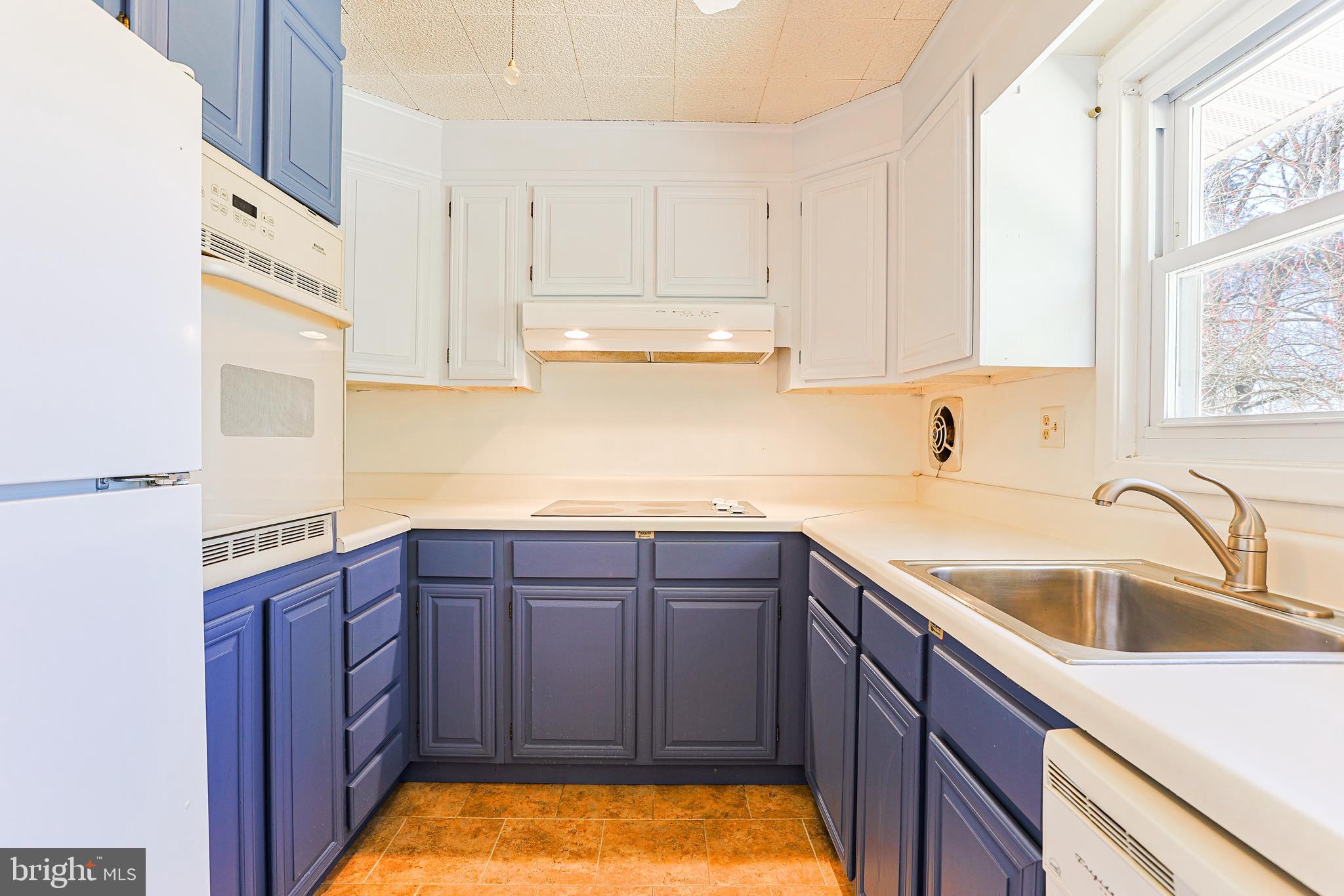 318 Exton Lane Exton, PA 19341 - Photo 10 of 41 a kitchen with stainless steel appliances granite countertop a sink dishwasher stove and cabinets with wooden floor