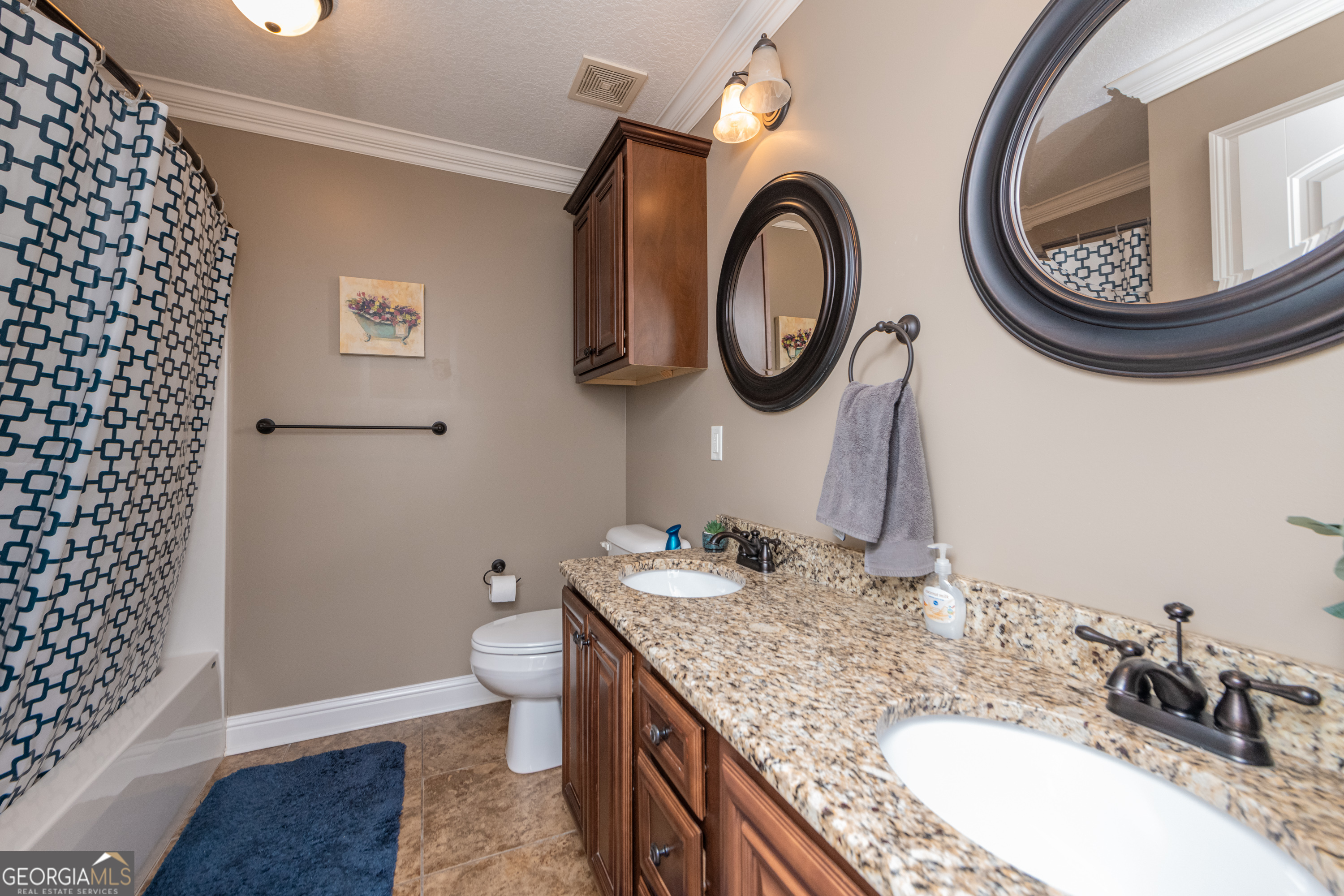 405 Old Bridge Road Warner Robins, GA 31088 - Photo 46 of 55 a bathroom with a granite countertop toilet a sink and a mirror