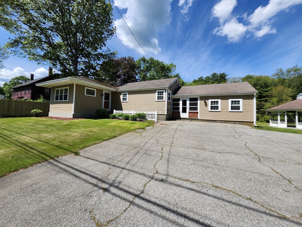 a front view of a house with yard and green space