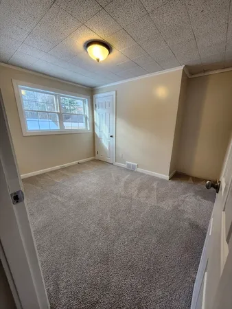 a outdoor space with a large window and furniture