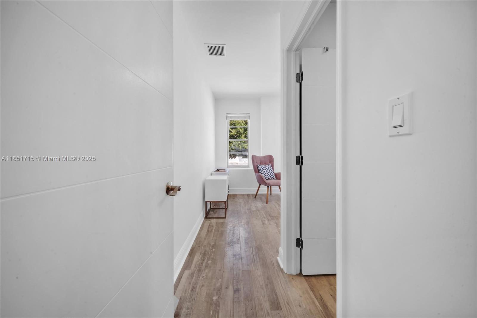 1520 Southwest 11th Terrace, Unit B Miami, FL 33135 - Photo 13 of 32 a view of a room with wooden floor lounge chair and windows