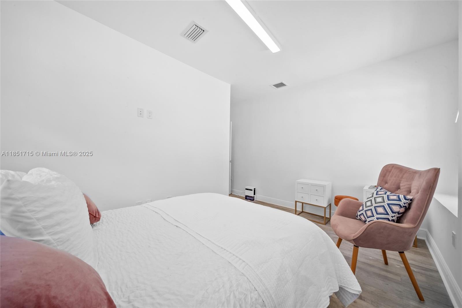 1520 Southwest 11th Terrace, Unit B Miami, FL 33135 - Photo 15 of 32 a bedroom with a bed and chair