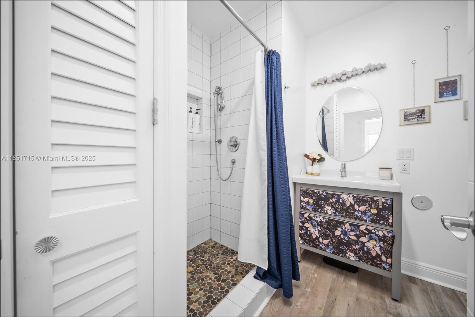 1520 Southwest 11th Terrace, Unit B Miami, FL 33135 - Photo 18 of 32 a bathroom with a mirror a sink and a shower