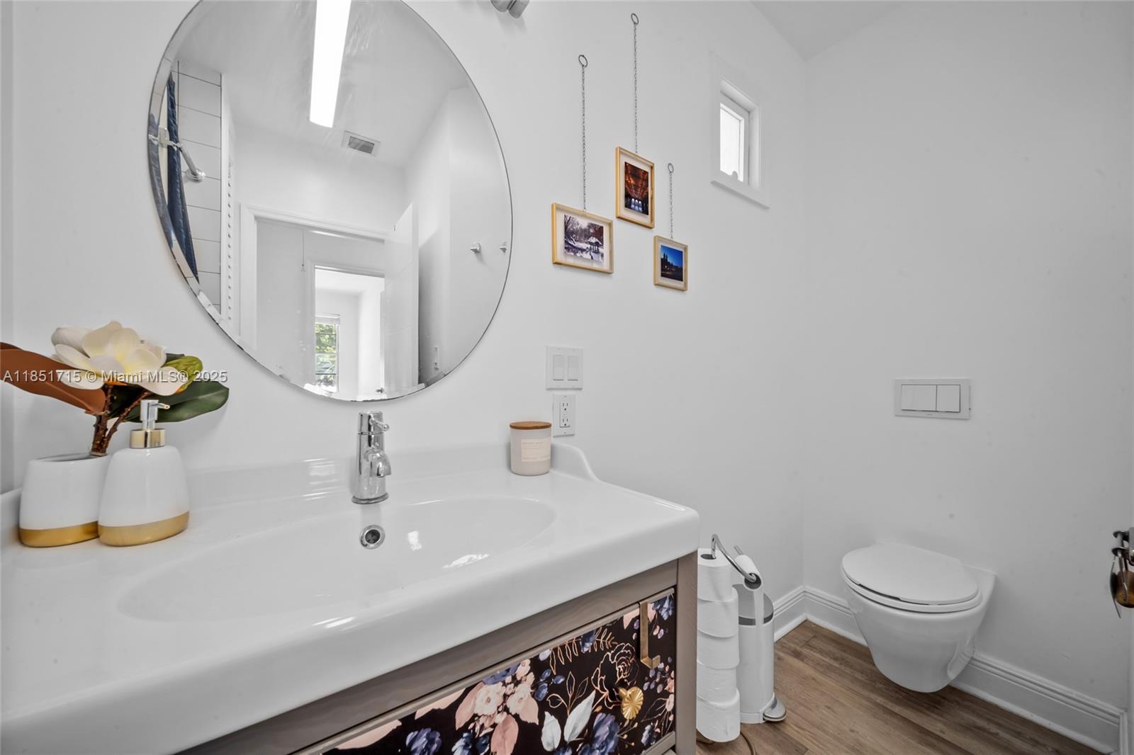 1520 Southwest 11th Terrace, Unit B Miami, FL 33135 - Photo 20 of 32 a bathroom with a sink a toilet and mirror