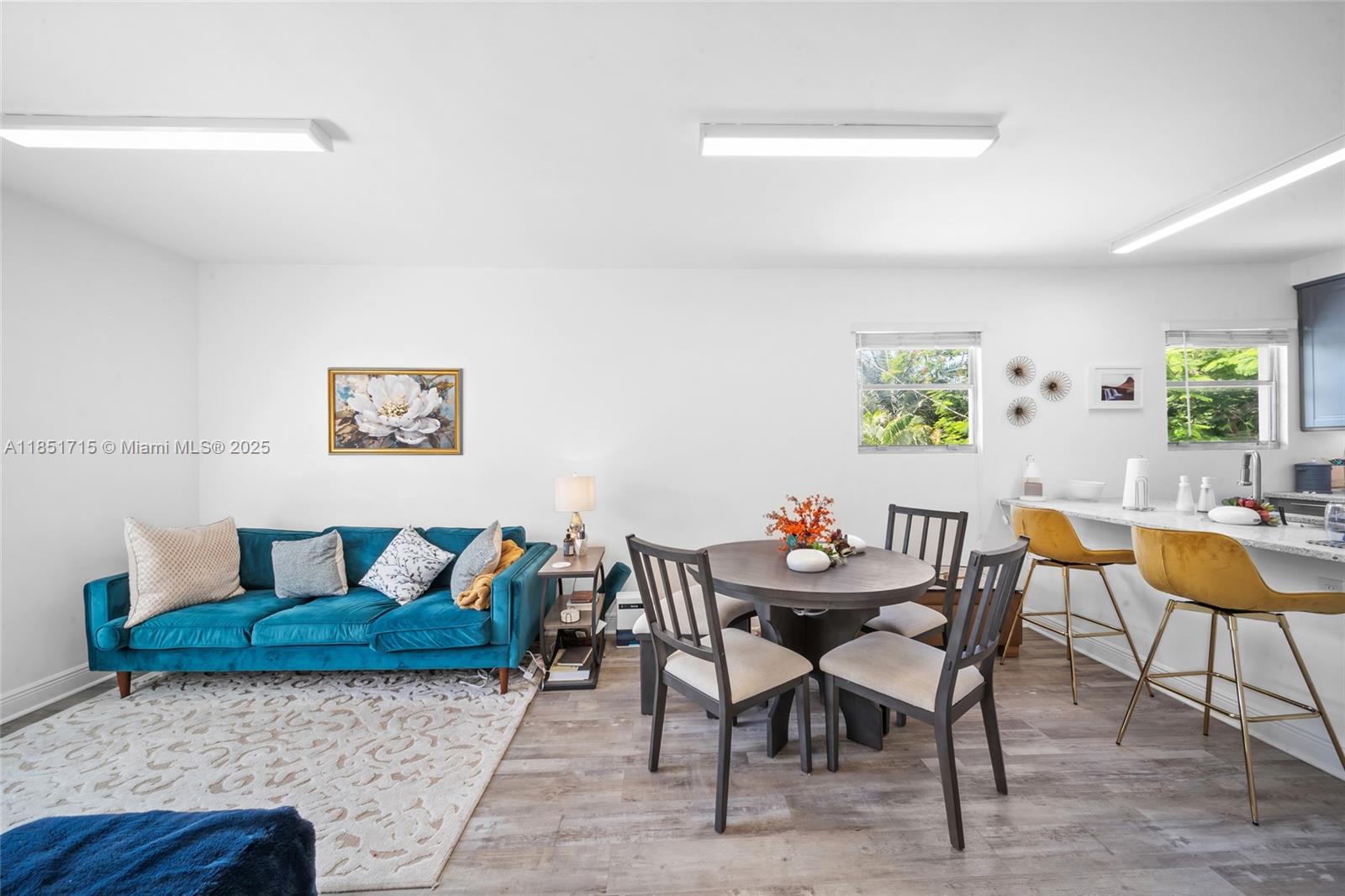 1520 Southwest 11th Terrace, Unit B Miami, FL 33135 - Photo 2 of 32 a view of a dining room with furniture and wooden floor