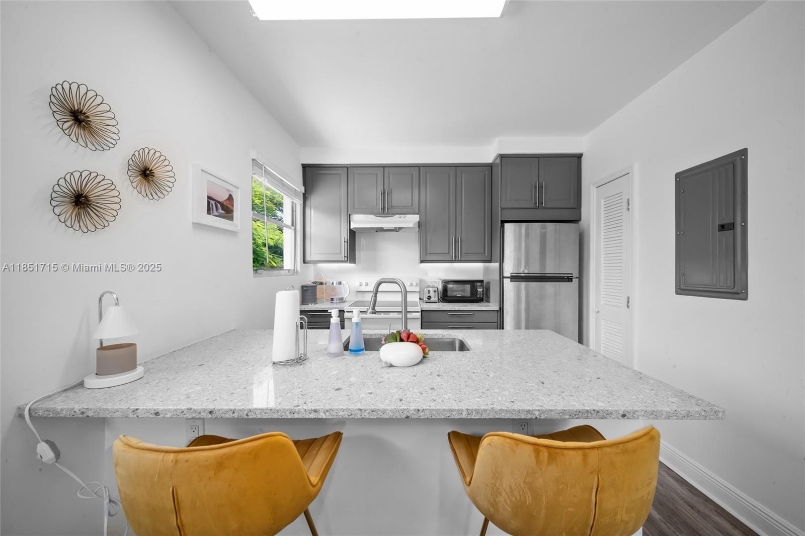 1520 Southwest 11th Terrace, Unit B Miami, FL 33135 - Photo 4 of 32 a kitchen with granite countertop cabinets and stainless steel appliances