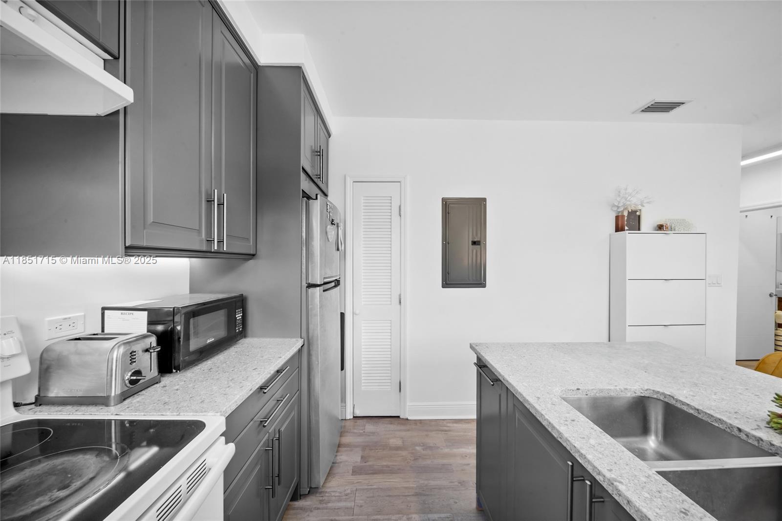 1520 Southwest 11th Terrace, Unit B Miami, FL 33135 - Photo 10 of 32 a kitchen that has a sink and a stove