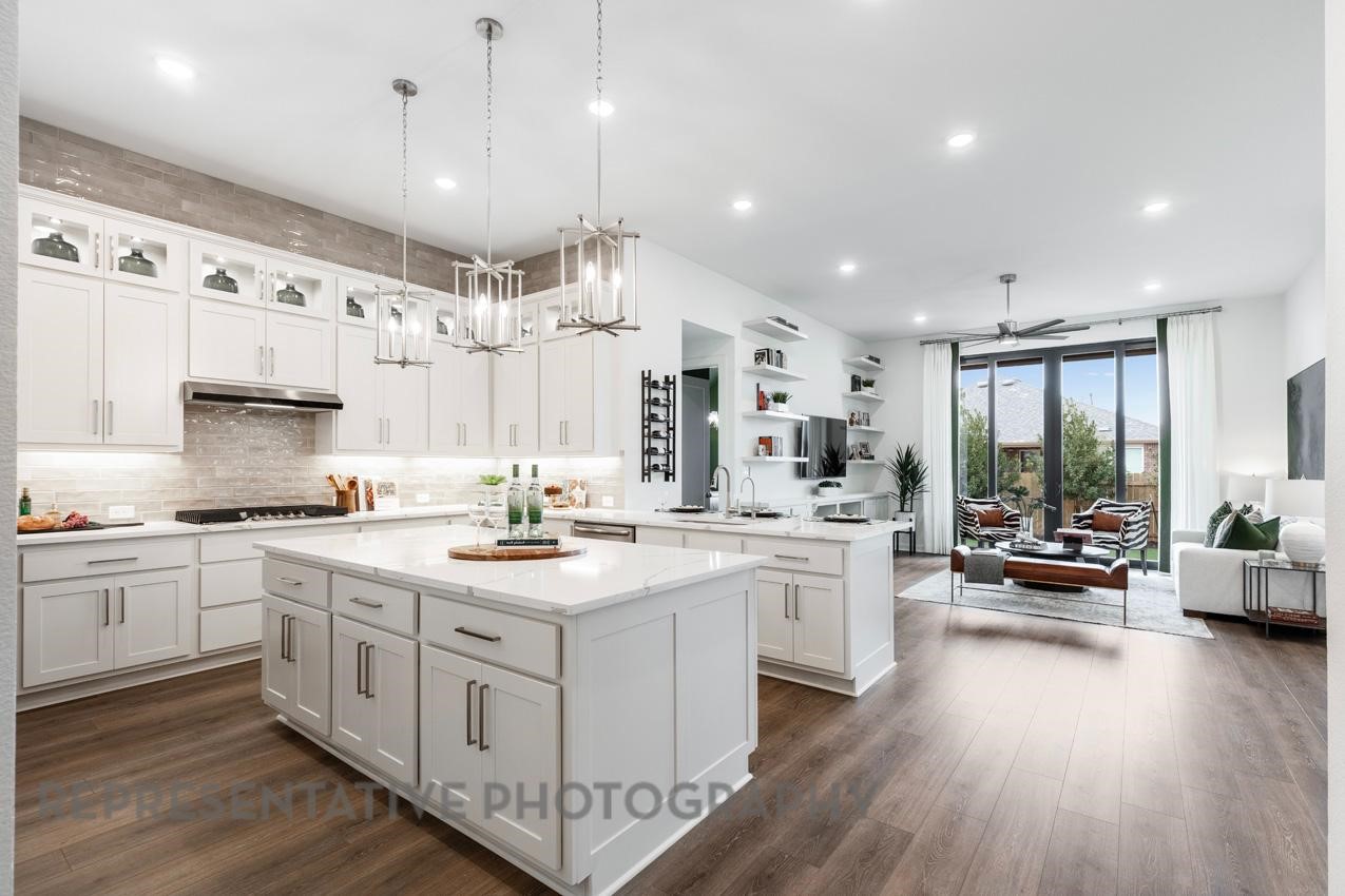 2714 Peach Vly Road Fulshear, TX 77423 - Photo 2 of 47 a kitchen with stainless steel appliances granite countertop a lot of counter space and wooden floors