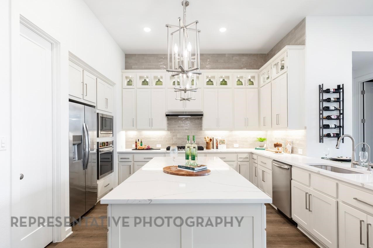 2714 Peach Vly Road Fulshear, TX 77423 - Photo 7 of 47 a large white kitchen with sink and refrigerator