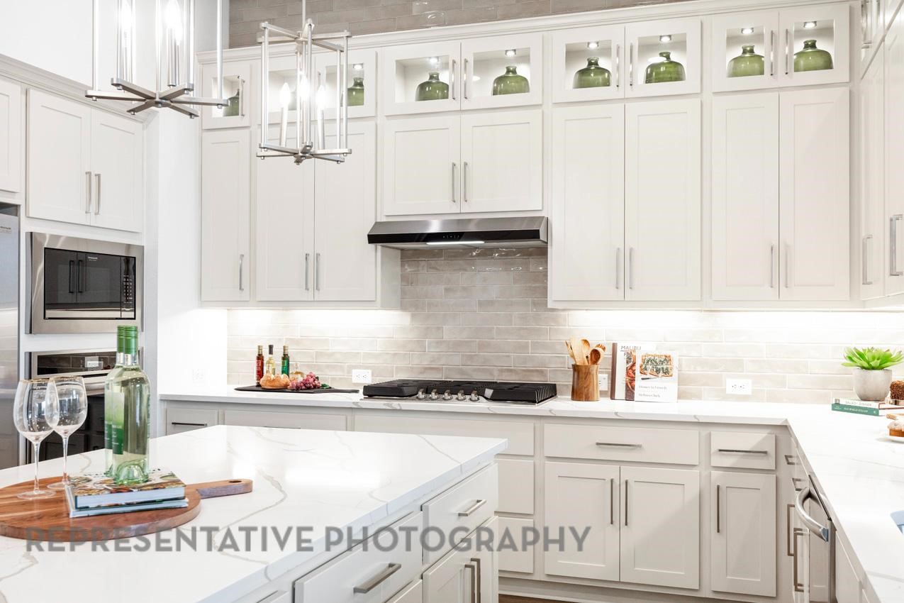 2714 Peach Vly Road Fulshear, TX 77423 - Photo 10 of 47 a kitchen with stainless steel appliances granite countertop a sink and cabinets