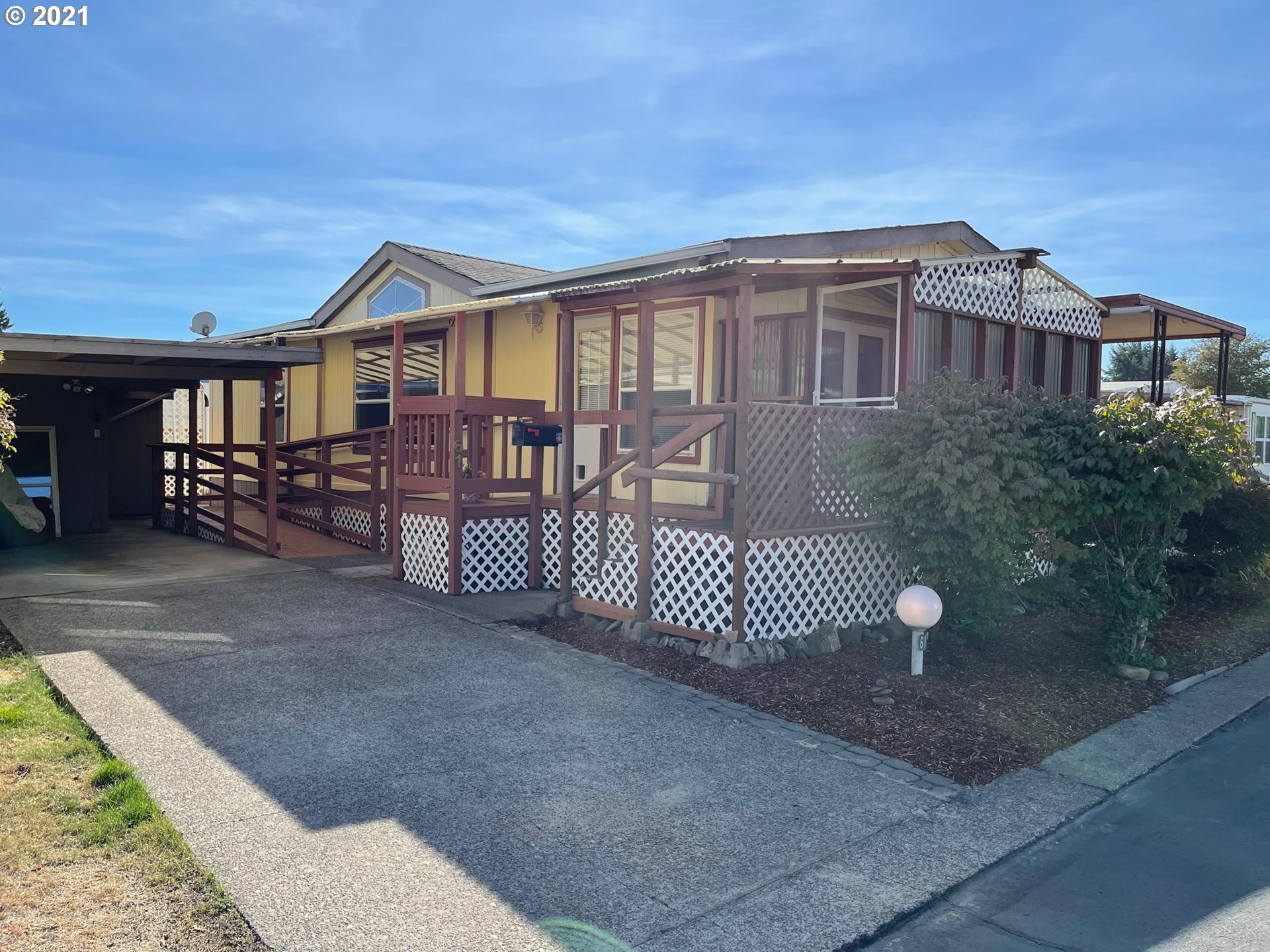 2150 Laura Street, Unit 61 Springfield, OR 97477 - Photo 2 of 24 a front view of a house with a yard