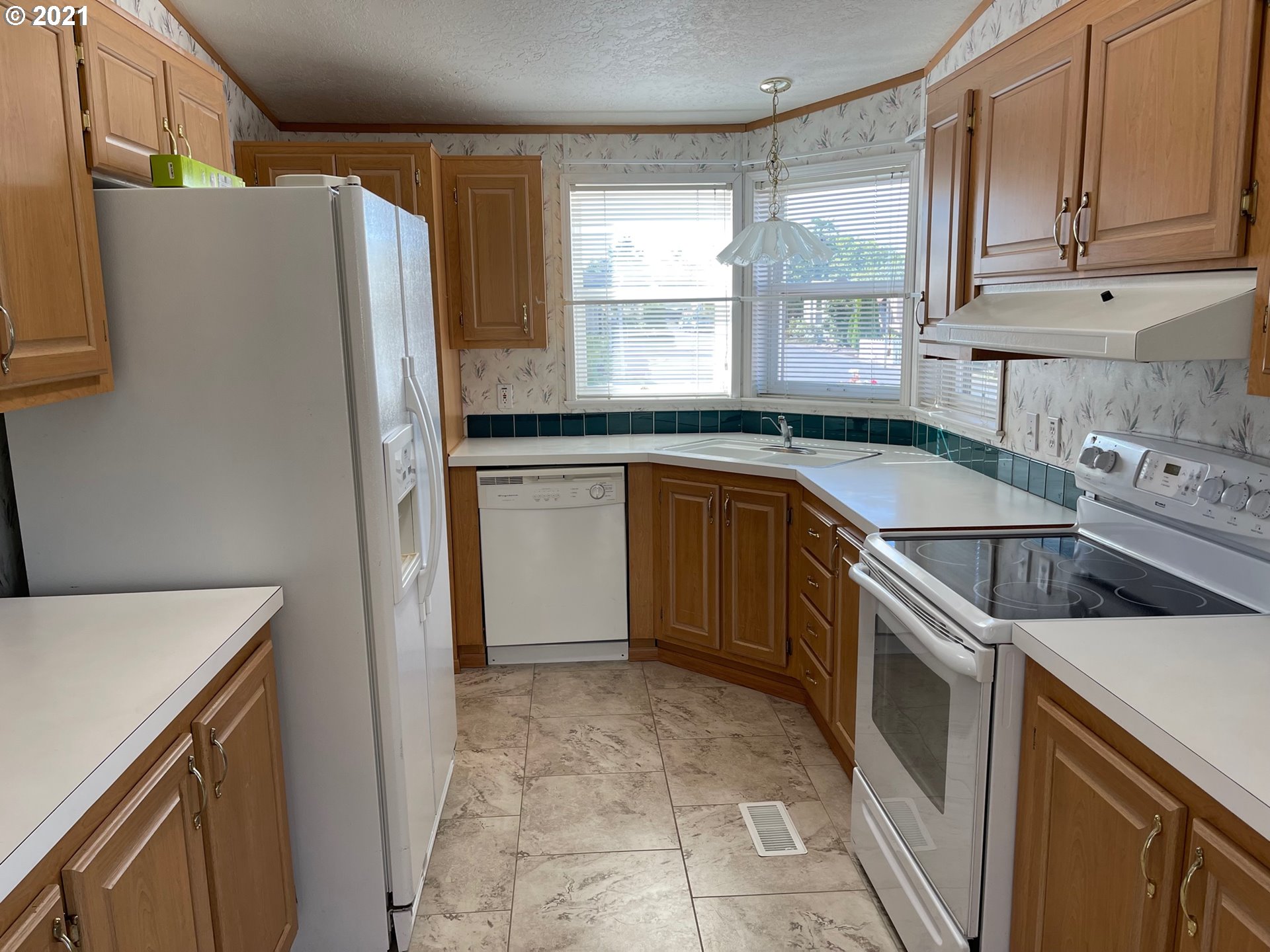 2150 Laura Street, Unit 61 Springfield, OR 97477 - Photo 12 of 24 a kitchen with a sink stove and refrigerator