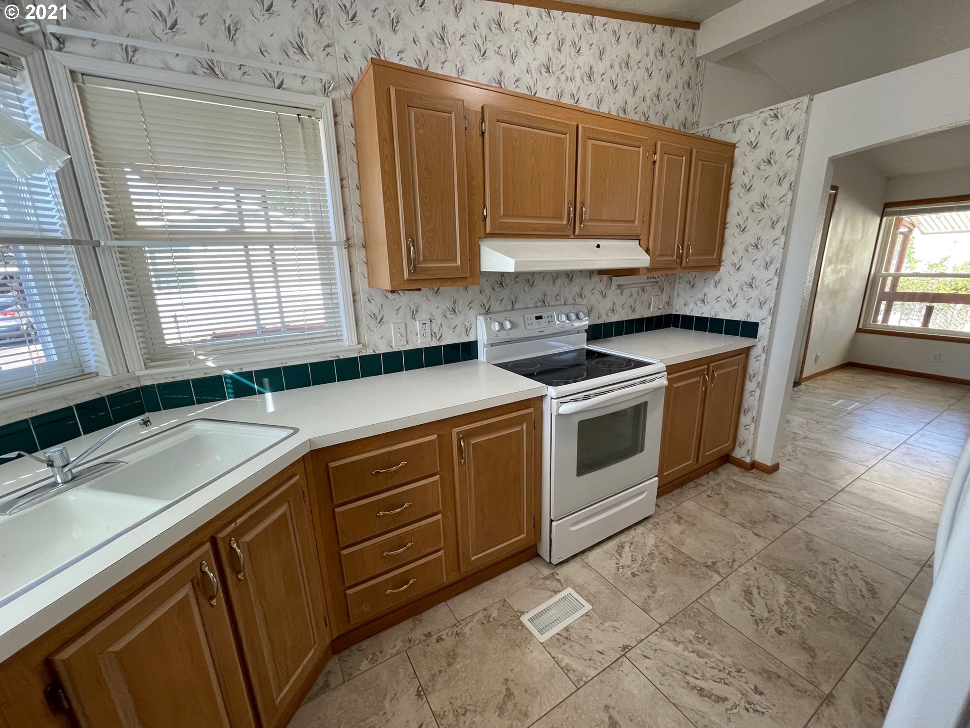 2150 Laura Street, Unit 61 Springfield, OR 97477 - Photo 13 of 24 a kitchen with stainless steel appliances granite countertop a sink a stove and a microwave