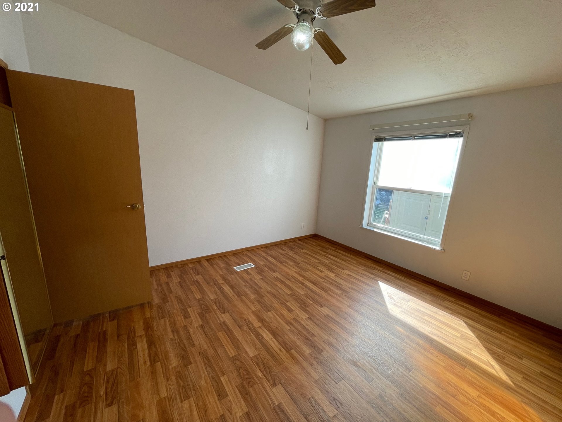 2150 Laura Street, Unit 61 Springfield, OR 97477 - Photo 21 of 24 an empty room with wooden floor closet and windows