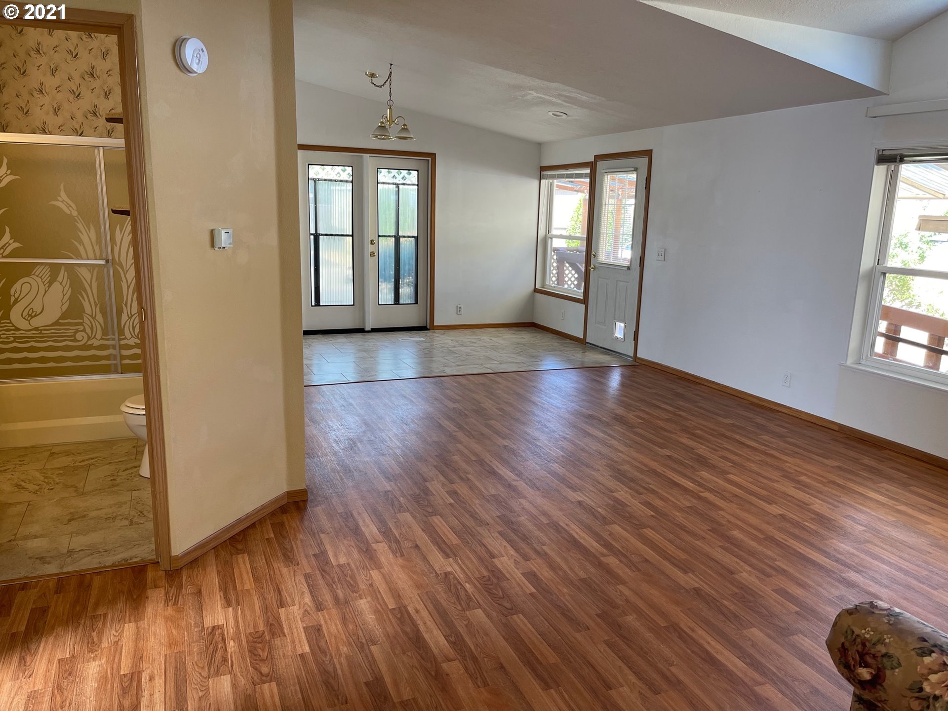2150 Laura Street, Unit 61 Springfield, OR 97477 - Photo 23 of 24 an empty room with wooden floor and windows