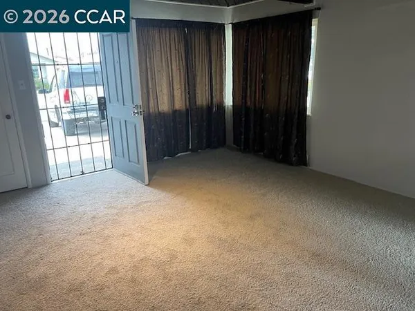 a view of an empty room with a window