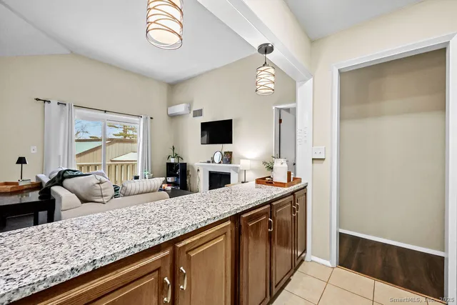 a view of living room with granite countertop furniture and a flat screen tv