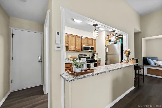 a kitchen with stainless steel appliances a refrigerator and a stove top oven