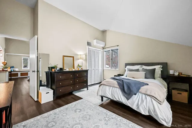 a spacious bedroom with a bed and a dresser