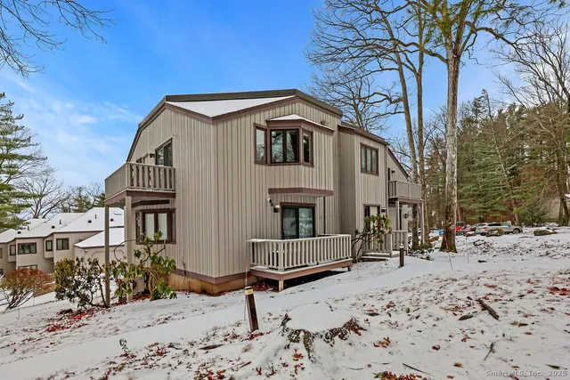 a view of a house with a yard covered in snow