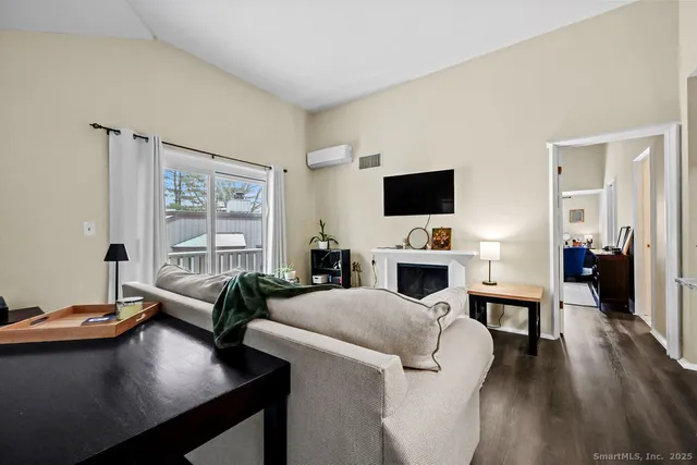 a living room with furniture a fireplace and a flat screen tv