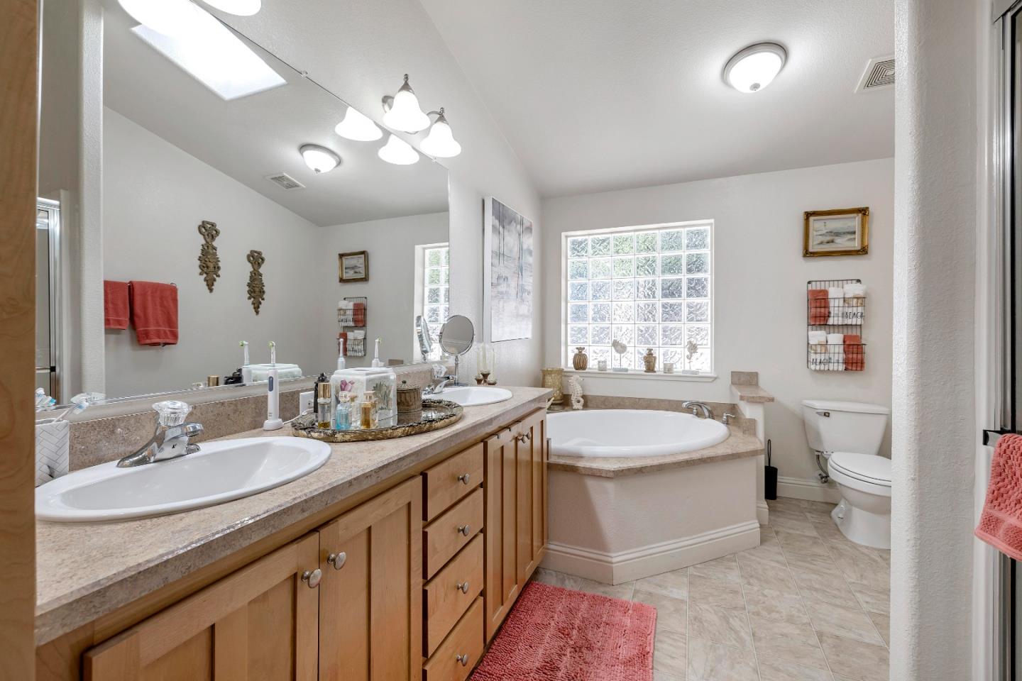 552 Filbert Street Half Moon Bay, CA 94019 - Photo 21 of 34 a bathroom with a sink double vanity granite tub and a mirror