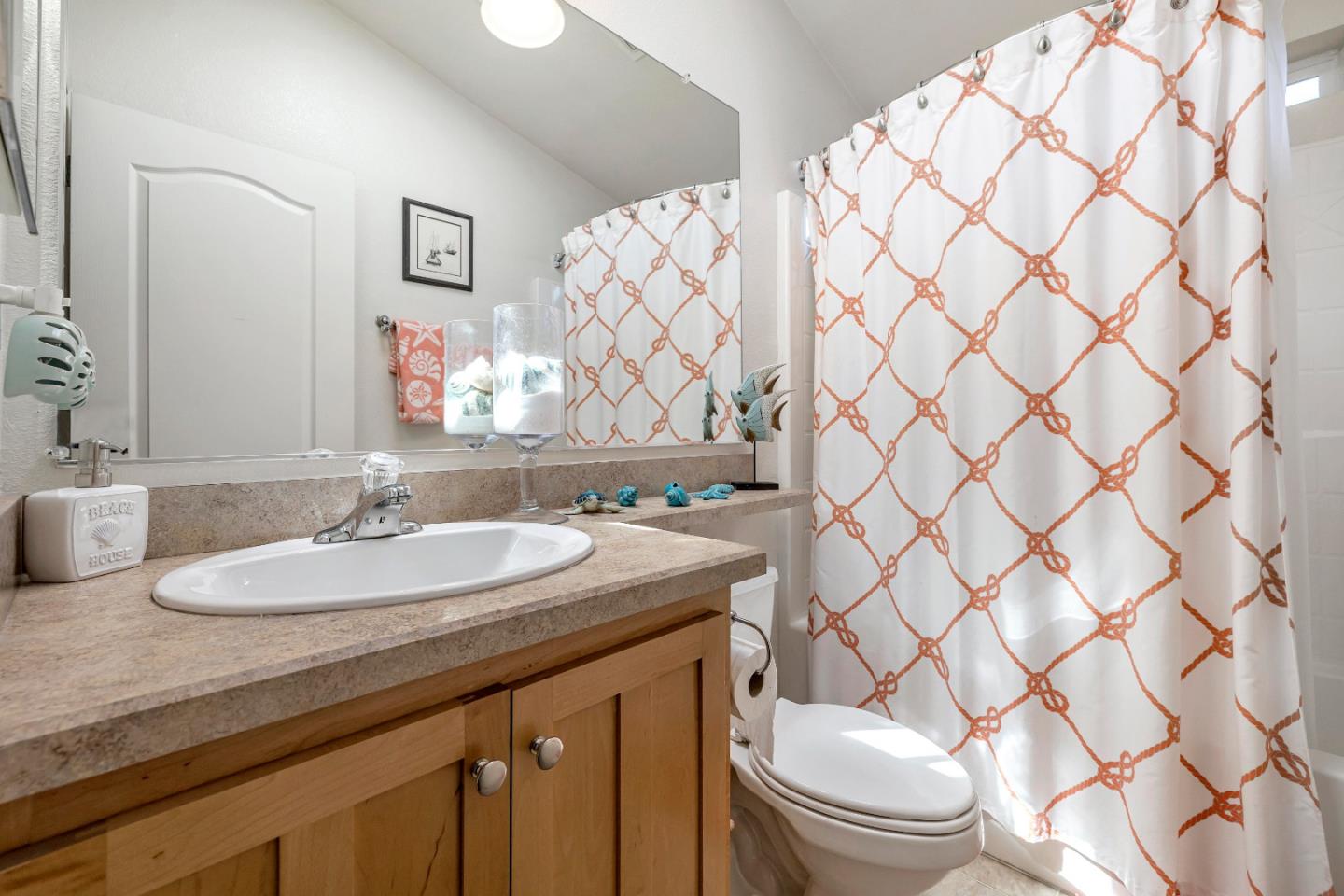 552 Filbert Street Half Moon Bay, CA 94019 - Photo 24 of 34 a bathroom with a granite countertop sink and a mirror
