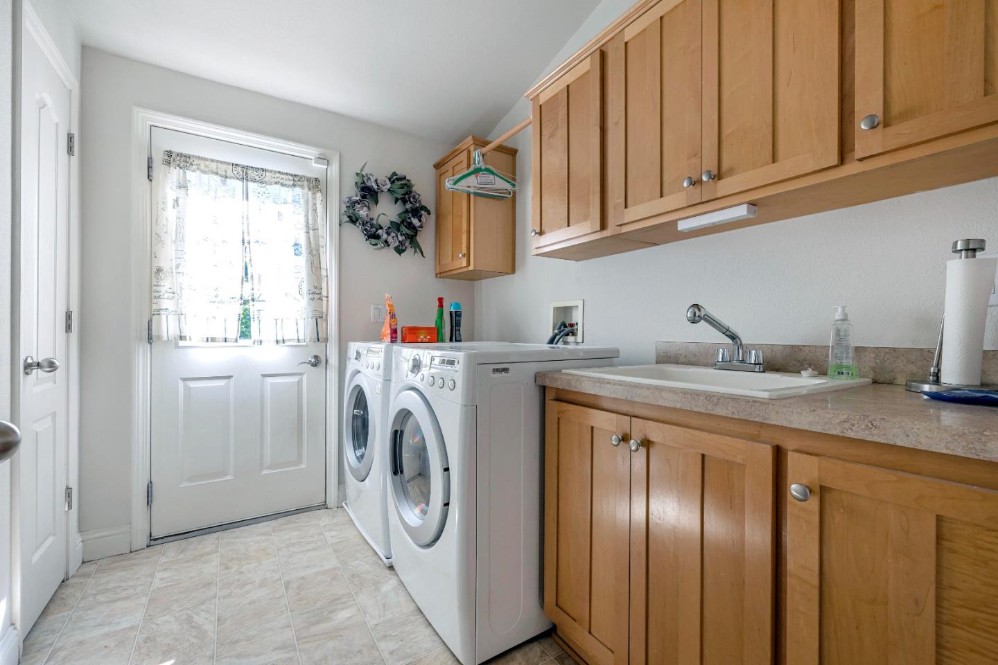 552 Filbert Street Half Moon Bay, CA 94019 - Photo 25 of 34 a utility room with cabinets washer and dryer