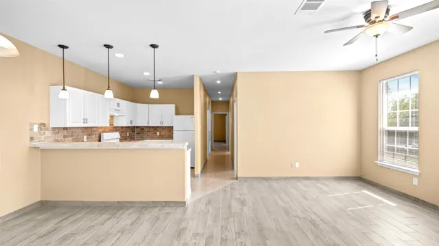 a view of a kitchen with wooden floor