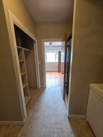 a kitchen with wooden cabinets and stainless steel appliances