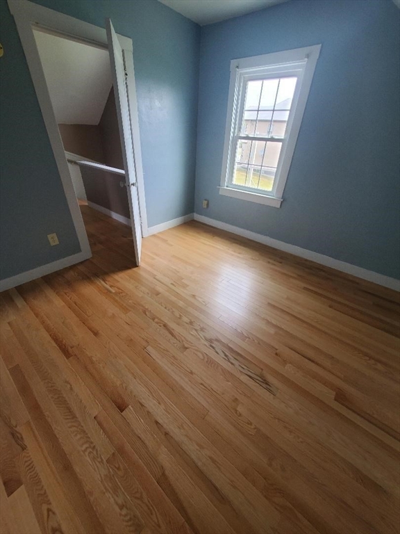 250 Laurel Street Fall River, MA 02724 - Photo 19 of 34 an empty room with wooden floor and windows