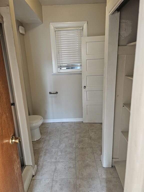 250 Laurel Street Fall River, MA 02724 - Photo 8 of 11 a bathroom with a granite countertop sink and a toilet