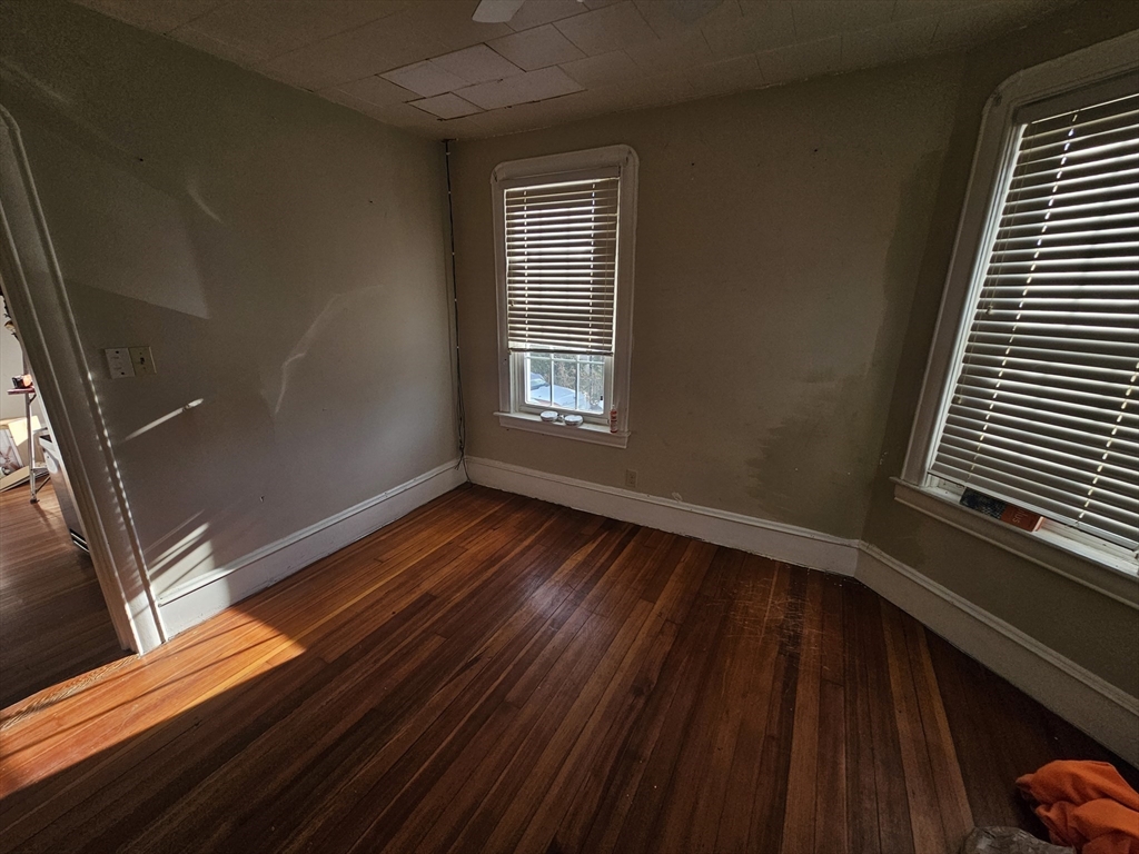 250 Laurel Street Fall River, MA 02724 - Photo 9 of 34 a view of an empty room with wooden floor and a window