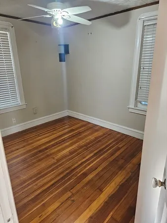 a view of hallway with stairs and a window