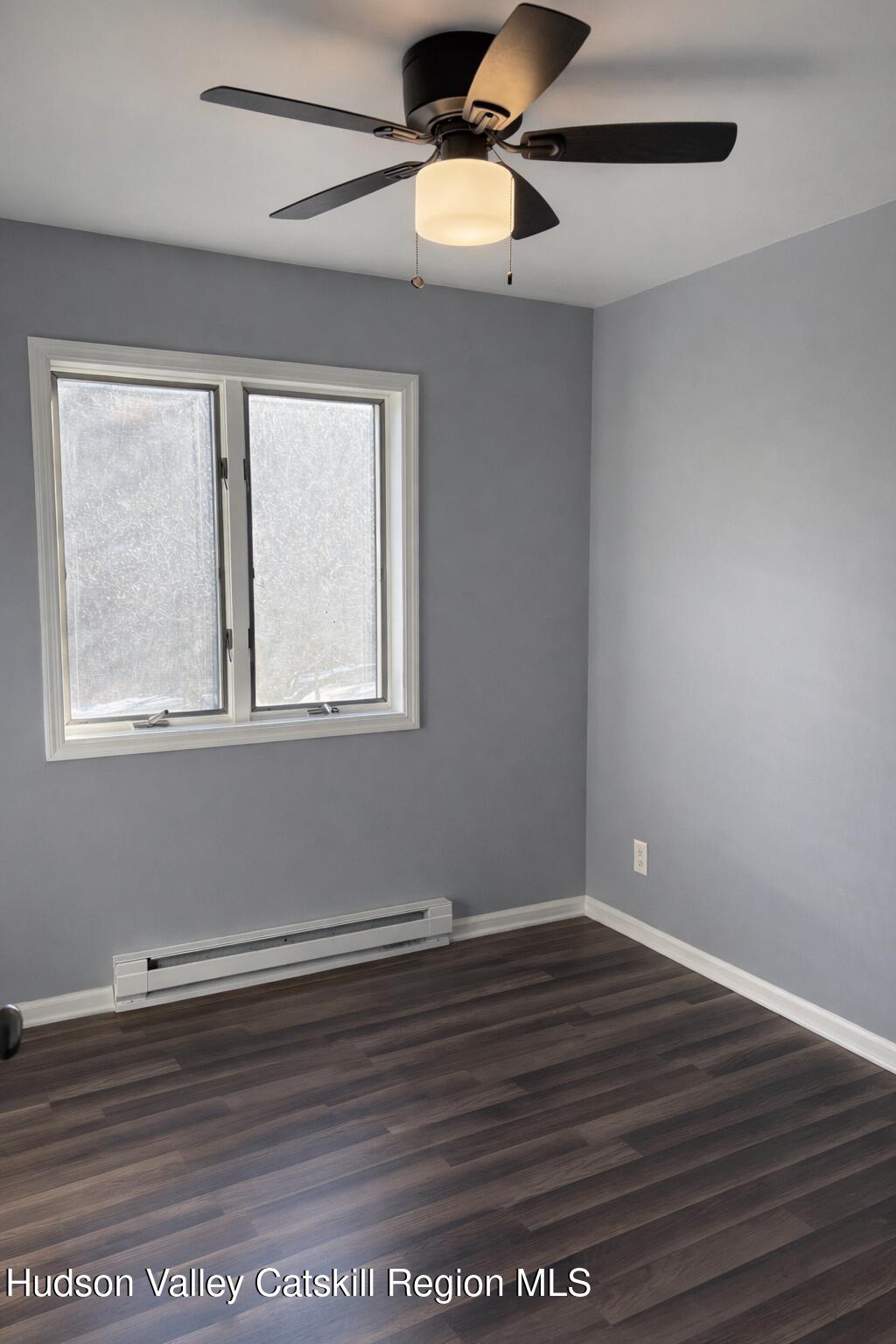 51 Hay Press Road Craryville, NY 12521 - Photo 16 of 27 a view of an empty room with wooden floor and a window
