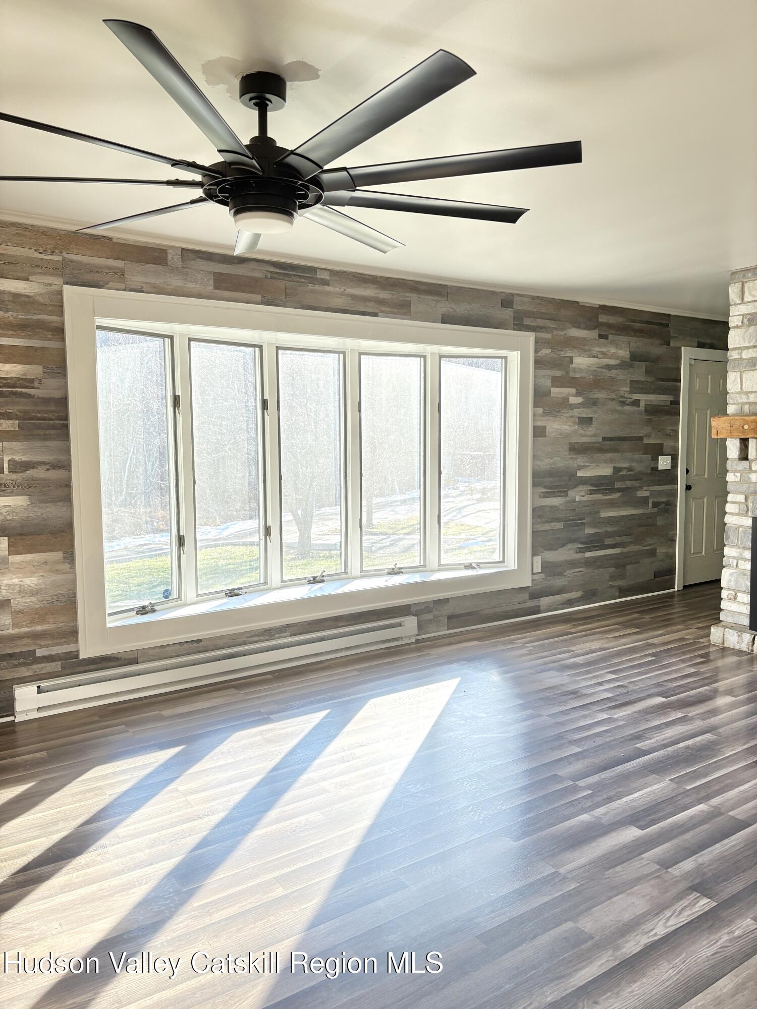 51 Hay Press Road Craryville, NY 12521 - Photo 4 of 27 a view of empty room with wooden floor and fan