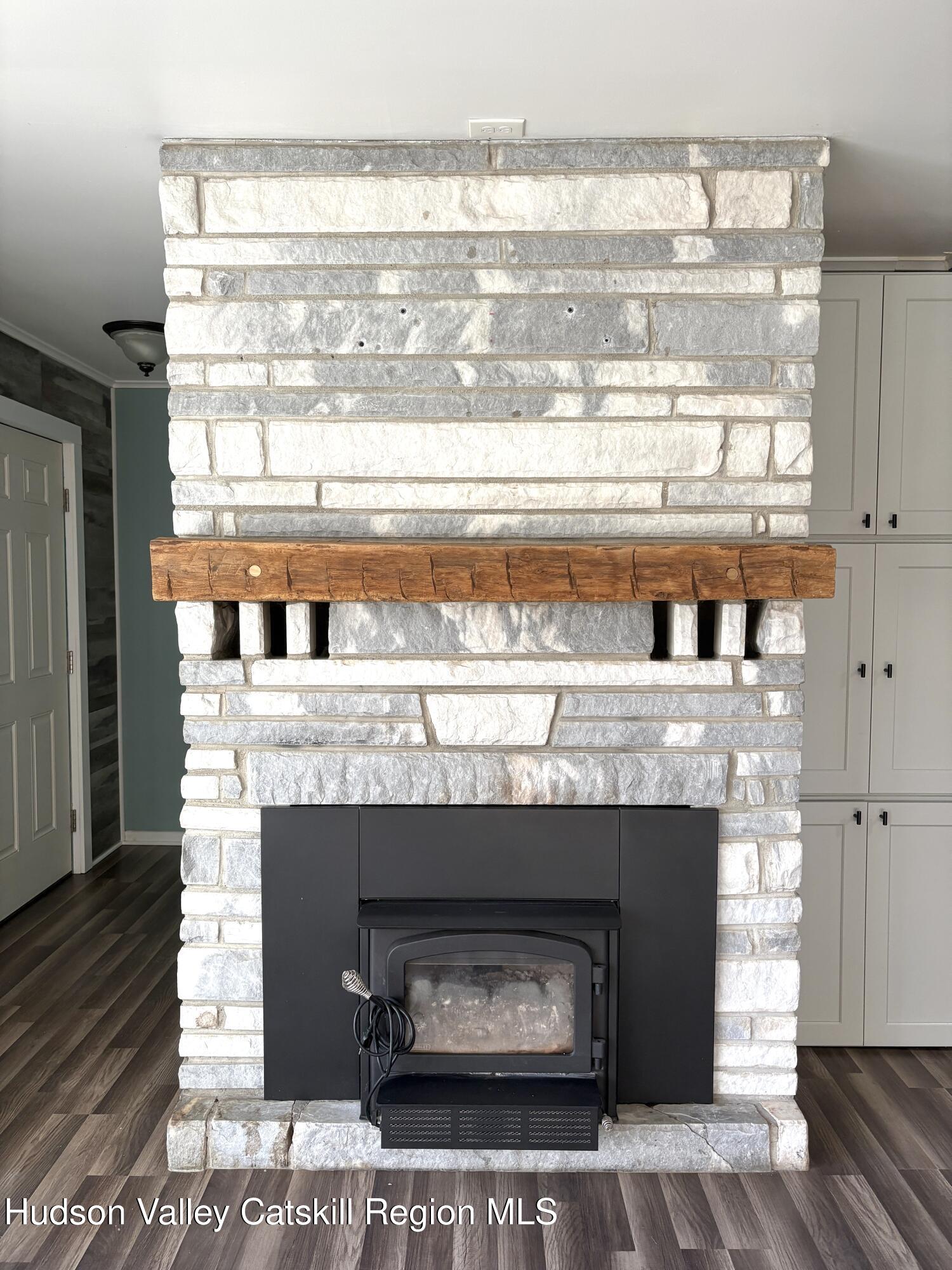 51 Hay Press Road Craryville, NY 12521 - Photo 6 of 27 a fireplace with a clock on top of it